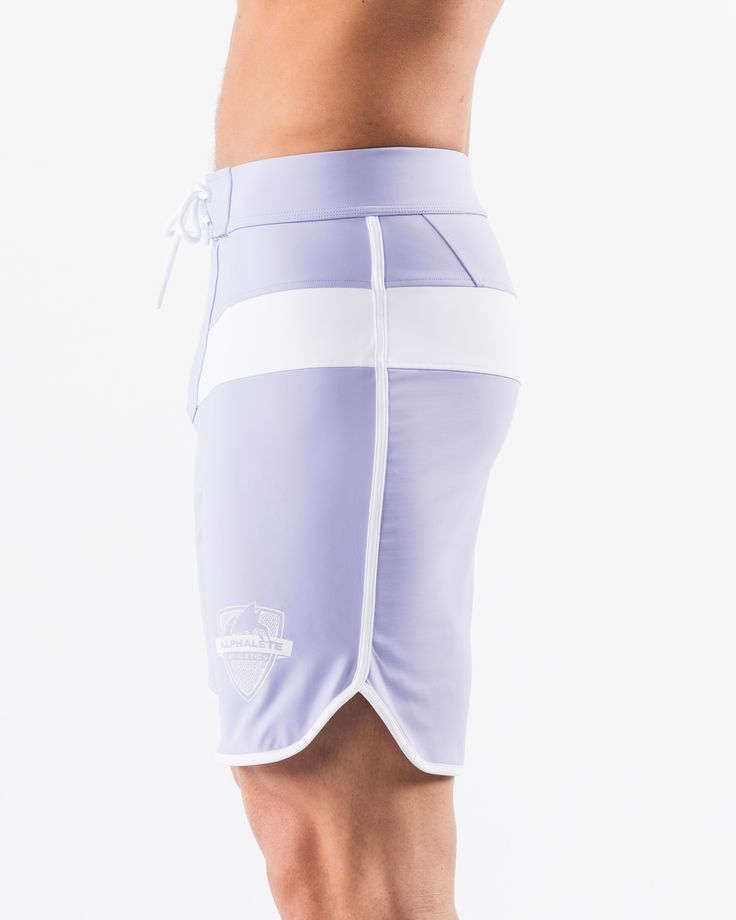 HIGHLIGHTS.. Unlined boardshort. 9” inseam Reflective branding at leg opening and back waistband Elastic waistband with adjustable self-tie drawcords Color-blocking panelling Water resistant fabric FIT SUGGESTION. This item runs true to Alphalete’s standard sizing.. Fit is based off of waist size in inches.. If you are between sizes, we recommend sizing up for a relaxed fit.. Eric is 6’2”/188cm, wearing a size 32. MATERIALS AND WASHING DIRECTIONS. 67% Nylon, 23% spandex. Due to the high saturati Sporty Fitted Tie-side Bottoms, Sporty Shorts For Water Sports, Sporty Fitted Surfing Bottoms, Athleisure Bottoms For Water Sports, Sporty Short Length Surfing Bottoms, White Sporty Swim Trunks For Water Sports, Sporty Swimwear With Elastic Waistband For Surfing, Sporty Fitted Shorts With Functional Drawstring, Workout Bottoms With Built-in Shorts And Tie-side