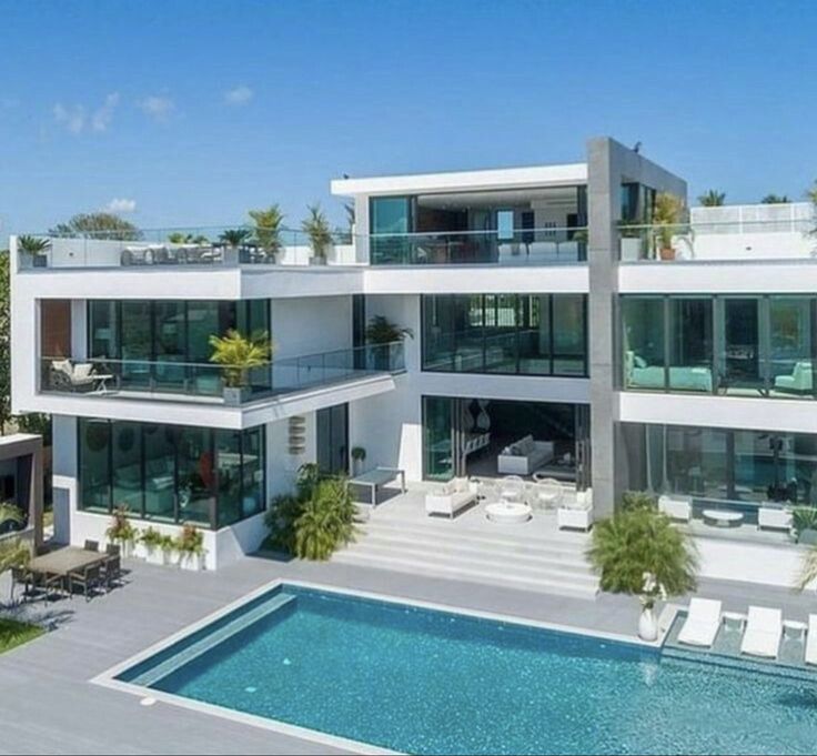 an aerial view of a modern house with pool