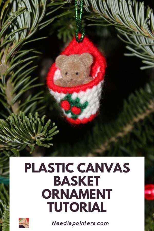 an ornament hanging from a christmas tree with the words plastic canvass basket ornament