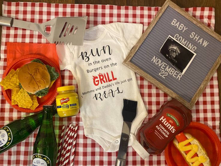 baby shower items laid out on a picnic table with utensils and other food