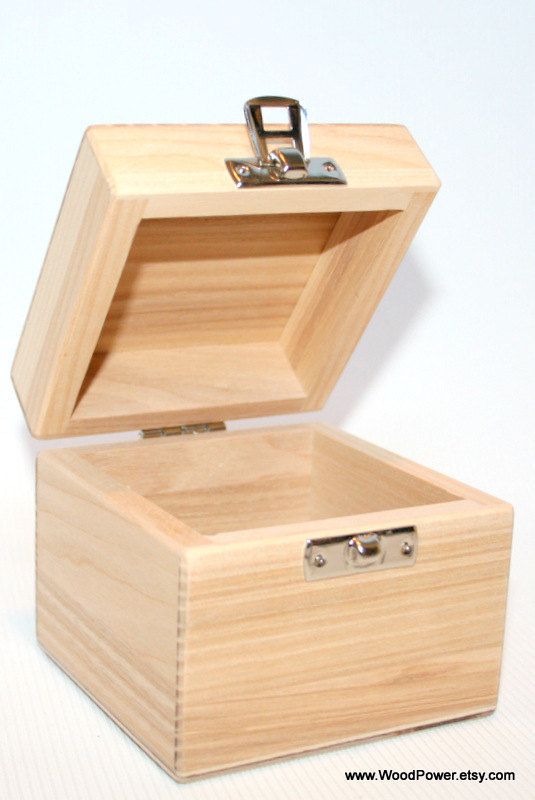 an empty wooden box with a lock on the lid and key in the top compartment