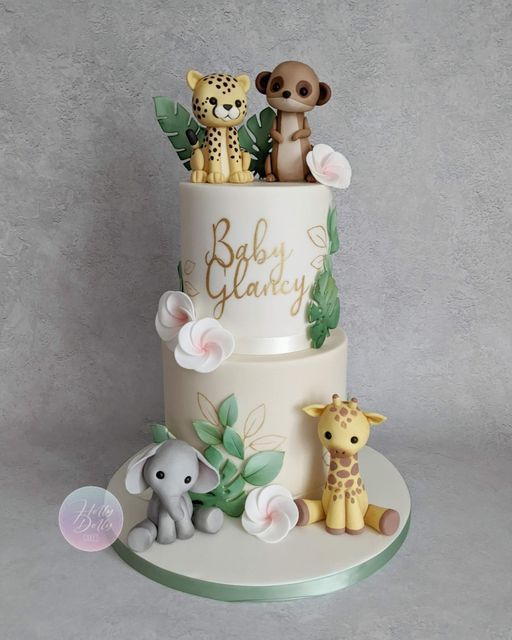 a baby shower cake with animals on top