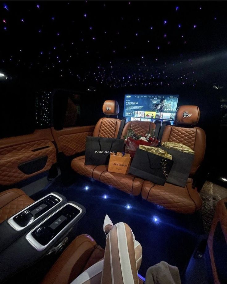 the interior of a luxury car with leather seats and accessories on display at an event