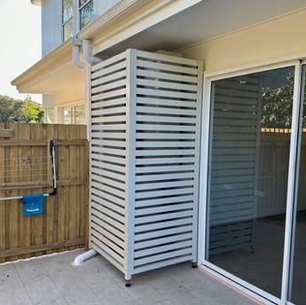 an outdoor patio with sliding glass doors and wooden fenced in area next to it