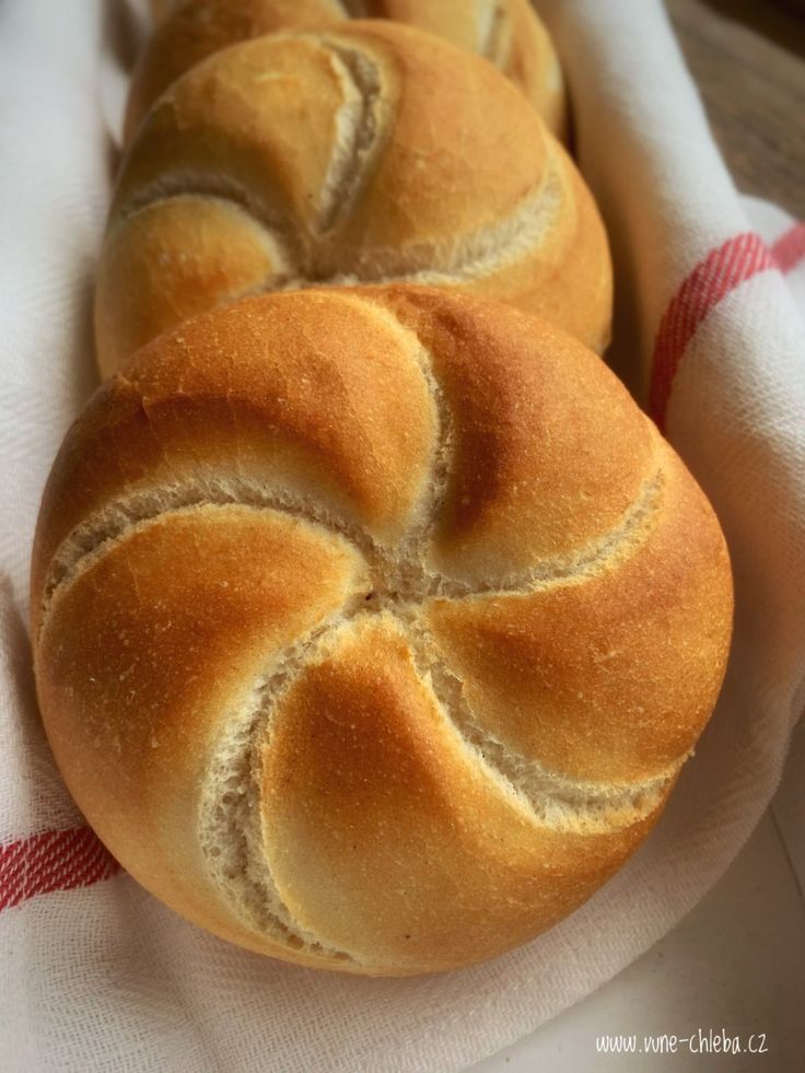 two loaves of bread sitting on top of a towel