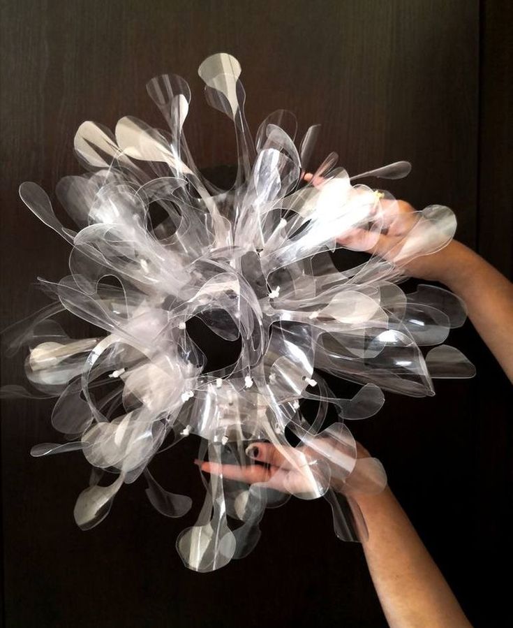 a person holding a bunch of clear plastic objects