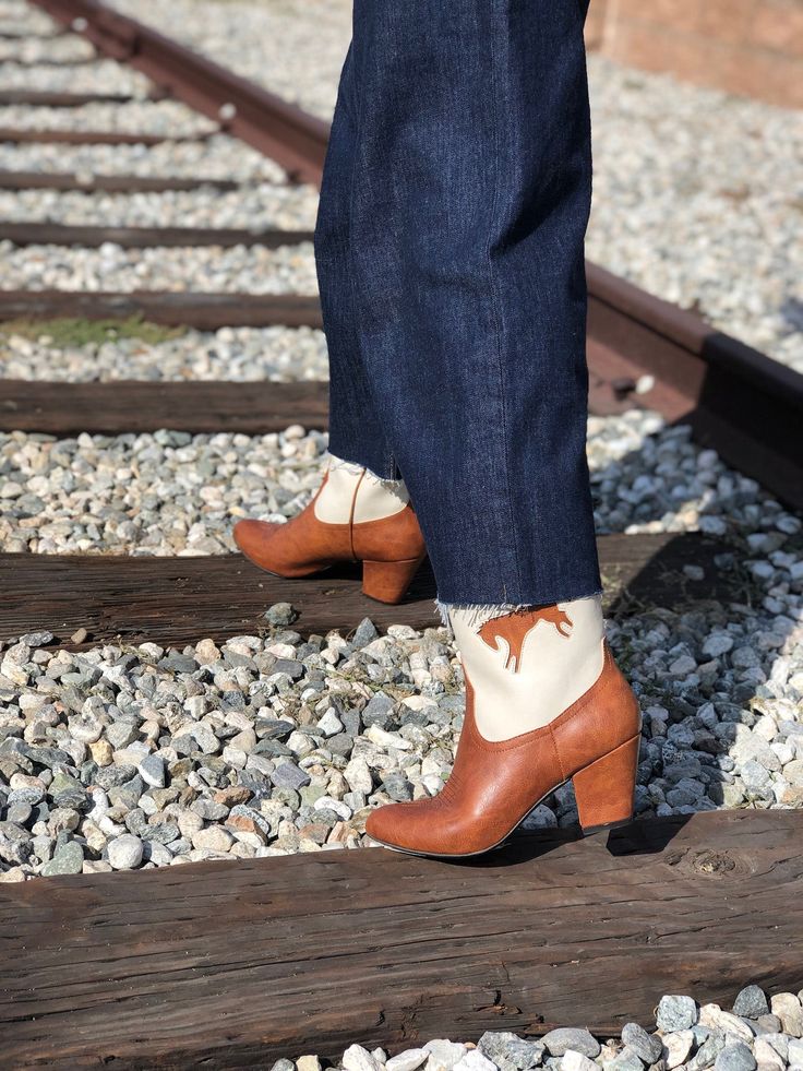 1950's Inspired Bucking Horse Adorned Western Boots. Proud To Be 100% Vegan Friendly. Upper Material: Faux Textured Leather Lining: Man Made + Fabric Step In Boot w/ Inner Tab For Easy Access. Heel Height: 3" Inches Approximate Shaft Height: (based on size 6 from top to back counter) 7 1/2" Inches / Mid Calf Height Fits True To Size, Please Size Up 1/2 If You Take A Wider Width. For Any Sizing Suggestions, Please Contact Customer Care. Imported Retro High-heeled Winter Boots, Retro High Heeled Winter Boots, Retro High Heel Winter Boots, Retro Medium Width Boots For Fall, Retro High Heeled Boots For Winter, Retro Fall Boots With Stacked Heel, Retro Spring Heeled Boots With Pointed Toe, Retro Boots With Stacked Heel For Fall, Vintage Pointed Toe Heeled Boots For Winter