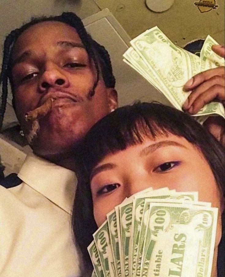 two people with money in their mouths