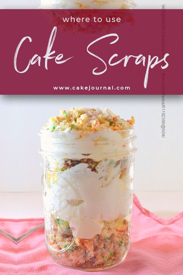 a jar filled with cake scraps sitting on top of a pink table cloth next to a