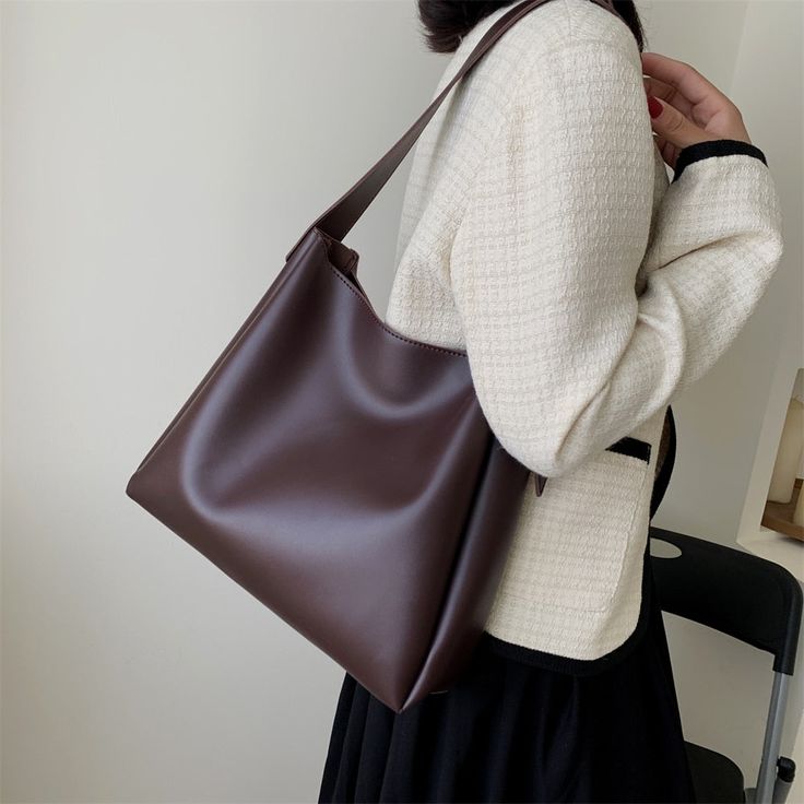 This faux leather shoulder tote bag is the perfect blend of style and functionality. Made from high-quality faux leather, it is durable and long-lasting, yet has a soft, supple feel. The shoulder strap is adjustable, allowing you to find the perfect length for comfortable carrying, and the top handle provides an alternative carrying option. Whether you're headed to the office or out for a weekend shopping trip, this tote bag is a chic and practical choice. Comes with an inside pouch with a zippe Stylish Tote Bag, Handbags And Purses, Side Bags, Women Bags Fashion, Large Shoulder Bags, Casual Tote, Bag Set, Bag For Women, Womens Tote