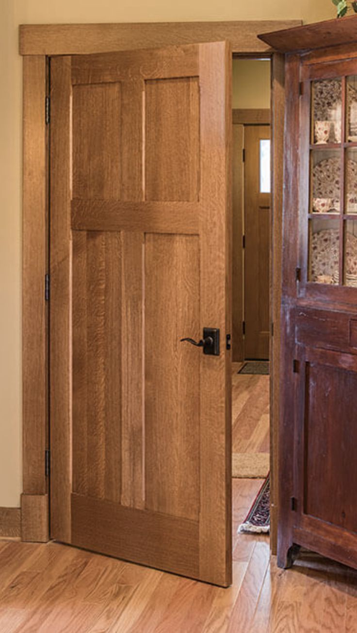 an open wooden door in the middle of a room