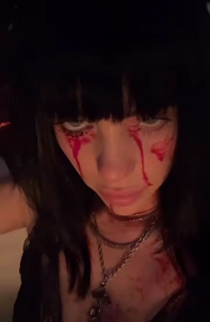 a woman with blood all over her face