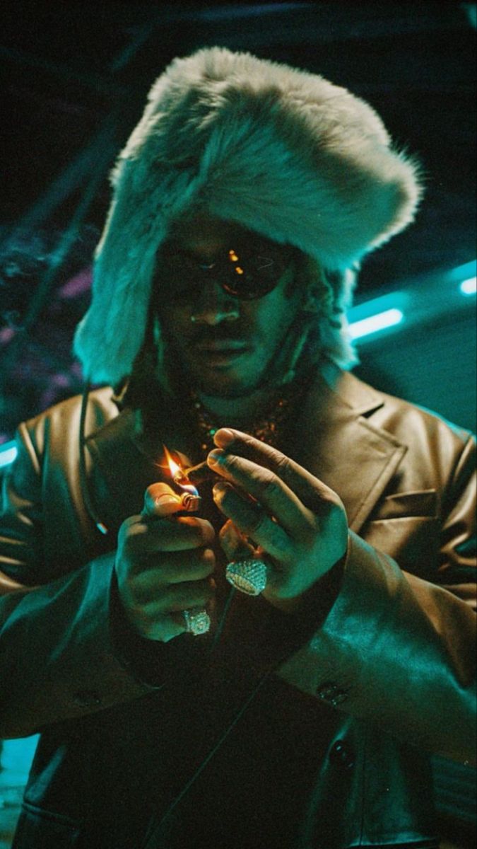 a man wearing a fur hat and holding a lighter