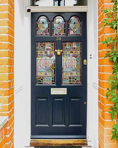 a blue door with stained glass on it