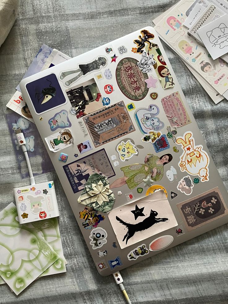 an open notebook covered in stickers and magnets