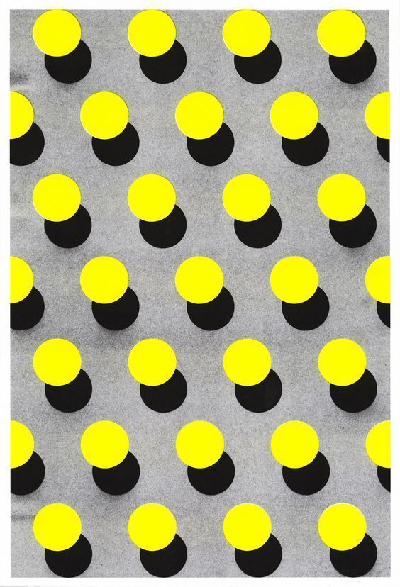 yellow and black circles are arranged on a gray surface