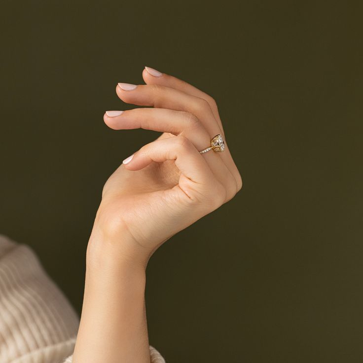 a woman's hand with a diamond ring on it