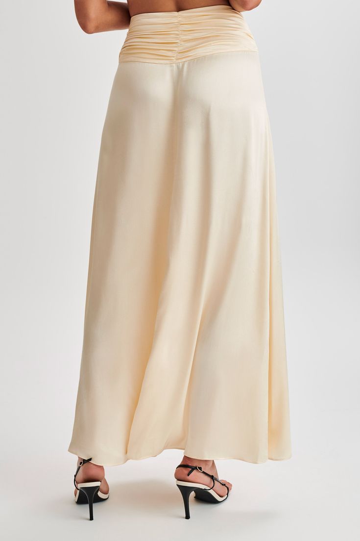 Ruched in all the right places.Unveil timeless elegance with the CLARA Satin Ruched Maxi Skirt, a luxurious piece that defines modern sophistication. The V waistline and ruched waist panel create a flattering silhouette, accentuating your curves with grace and style. The side zip ensures a seamless fit, while the full hem adds a touch of drama, making this maxi skirt a statement piece for any occasion. Clara is not just a skirt; it's an embodiment of contemporary glamour, designed for the woman Women Clothing Boutique, Ladies Boutique, Halter Top, Boutique Clothing, Butter Cream, Side Zip, Timeless Elegance, Nice Dresses, Maxi Skirt