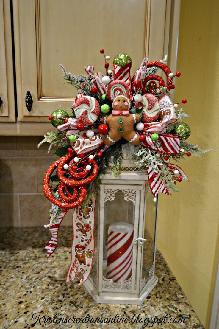 a lighted lantern decorated with candy canes and christmas decorations