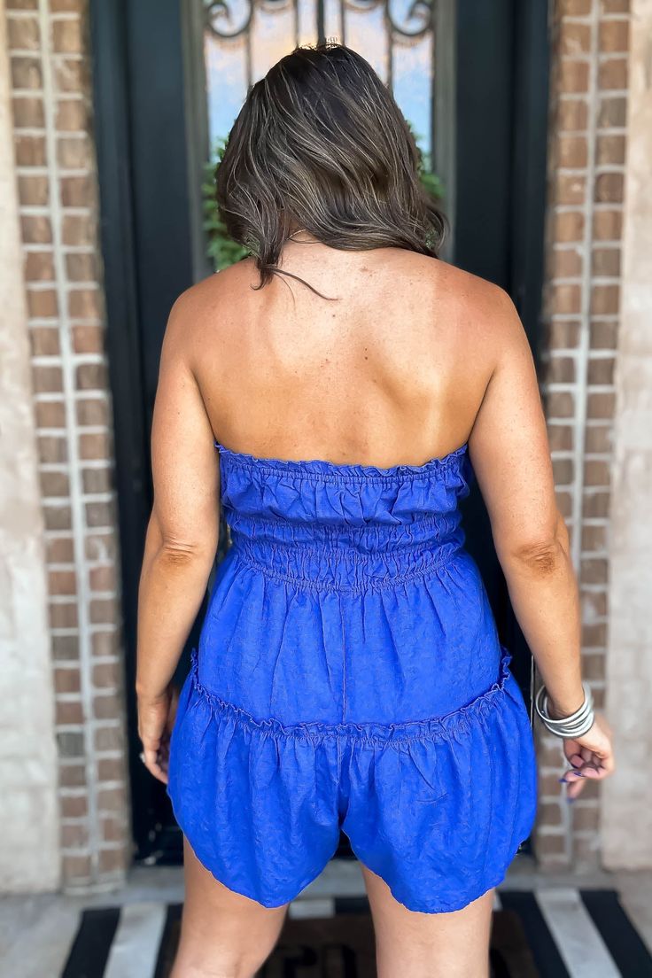 Let the good times roll in this Royal Blue Flare Tube Romper. With its playful blue hue and flirty flared legs, you'll stand out from the crowd. Perfect for sunny days and summer strolls, this romper is a must-have for any fashion-forward individual. Get ready to turn heads and have some fun! Fit: She is wearing her true size medium. Fits true to size. If in between sizes, size up. Flirty Mini Length Summer Jumpsuits And Rompers, Summer Beach Jumpsuits And Rompers Mini Length, Summer Beach Mini Jumpsuits And Rompers, Casual Mini Length Jumpsuits And Rompers For Beach, Flirty Summer Jumpsuits And Rompers For Vacation, Flirty Summer Vacation Jumpsuits And Rompers, Spring Vacation Mini Length Jumpsuits And Rompers, Flirty Summer Jumpsuits And Rompers For Day Out, Blue Mini Length Jumpsuits And Rompers For Summer