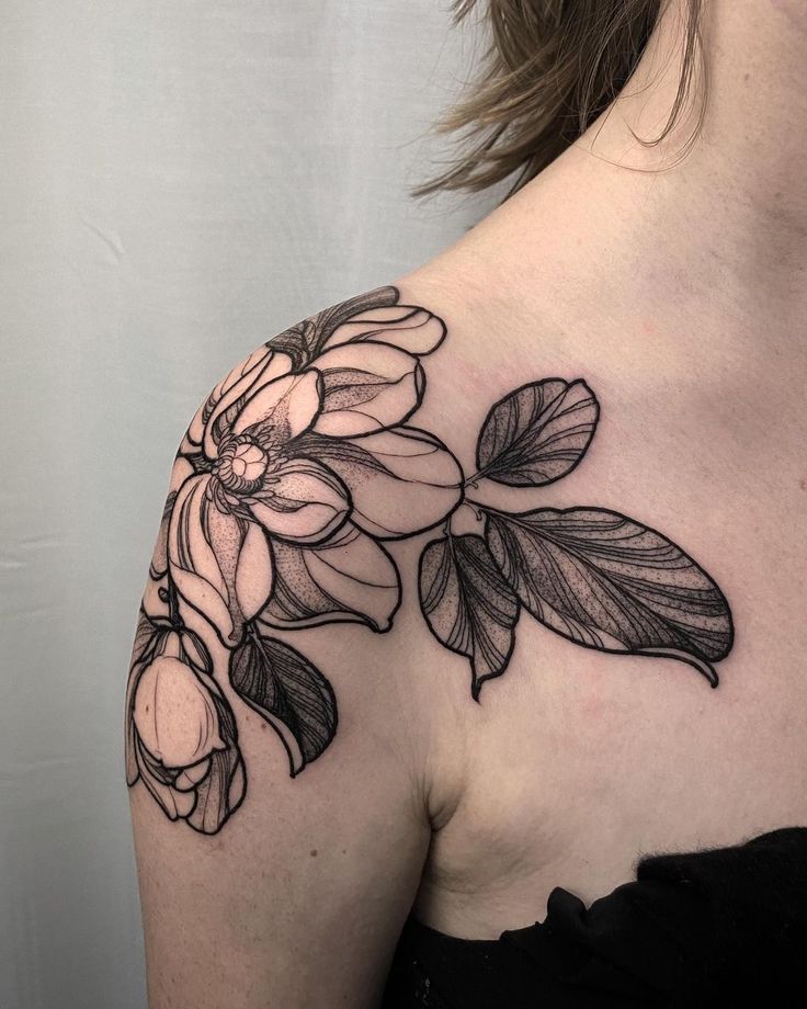 a woman's shoulder with flowers on it