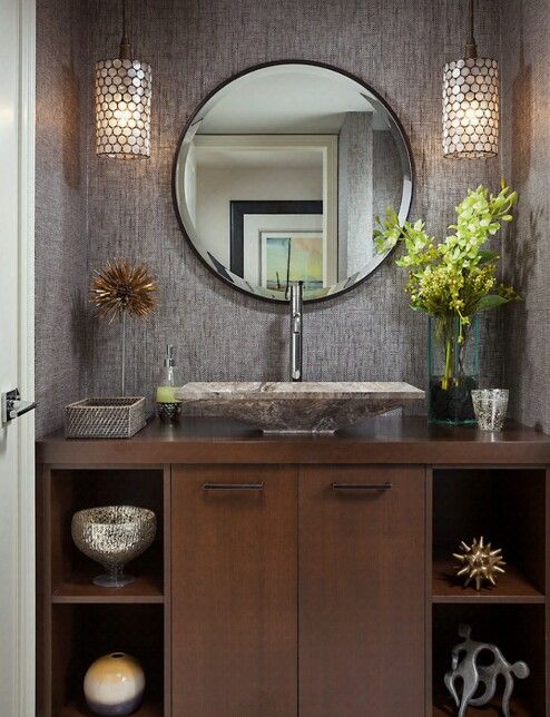 a bathroom with a sink and mirror on the wall above it's cabinetry