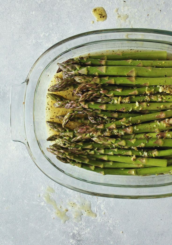 asparagus in a glass dish on a table