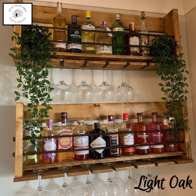 a wooden shelf filled with lots of bottles and glasses