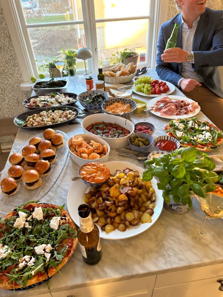 a man standing in front of a table full of food