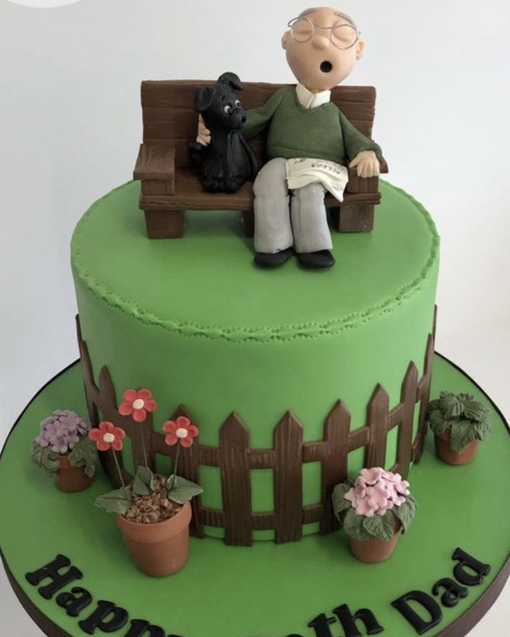 a birthday cake with a man sitting on a bench