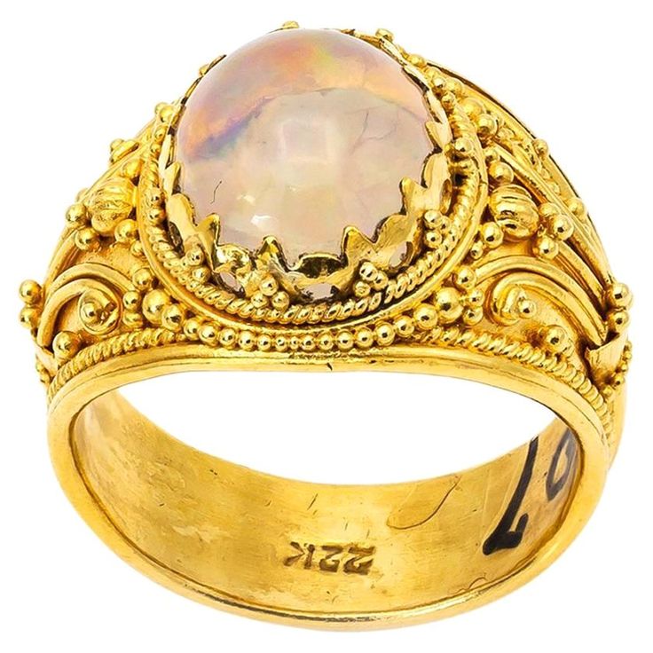 This gorgeous intricate jelly opal ring dazzles in 22K yellow gold. Detailed and shiny the gold glows with spirals and swirls in a traditional Balinese fashion. Rainbows reflect out of this light white cabochon opal as the setting celebrates artistic aesthetic. Size 7. Opal Gold Ring, Jelly Opal, Red Opal, Artistic Aesthetic, Opal Ring Gold, Lapis Lazuli Ring, Gold Cocktail Ring, Gold Ring Sets, Orange Sapphire