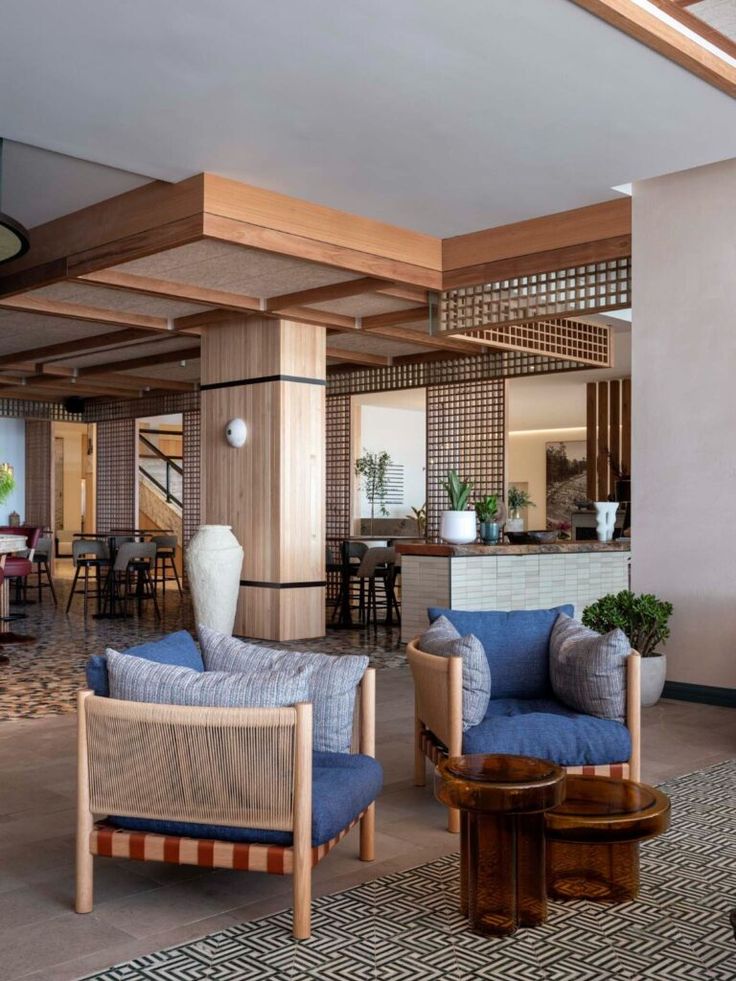 a living room filled with lots of furniture next to a dining room table and chairs