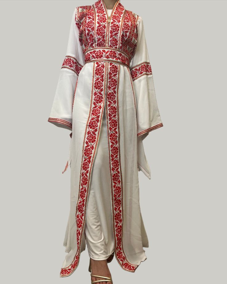 Our Eve Red Tatreez Embroidered Palestinian Kaftan Thobe (2 Piece Set) is a beautiful dress for a special occasion! It is simple, elegant and perfect for the next Palestinian katib ktab or wedding. It is a two piece set including the chiffon kaftan thobe and a matching long-sleeve inner slip dress. The Eve Thobe comes with belt with tatreez, and can be adjusted as you wish! DetailsAvailable in Black with Red Tatreez, Black with Red and Gold Tatreez, and White with Red Tatreez Please note that the embroidery on this dress is machine stitched, found on the front and back of the dress. Size GuideSize may run large.Size 1 - Bust: 38" all around, Length: 59"Size 2 - Bust: 40" all around, Length: 59"Size 3 - Bust: 42" all around, Length: 59"Size 4 - Bust: 44" all around, Length: 59"Size 5 - Bust Chiffon Kaftan, Oc Stuff, Business Tops, Arab Women, Simple Elegant, Two Piece Set, Red And Gold, 2 Piece Set, Beautiful Dress