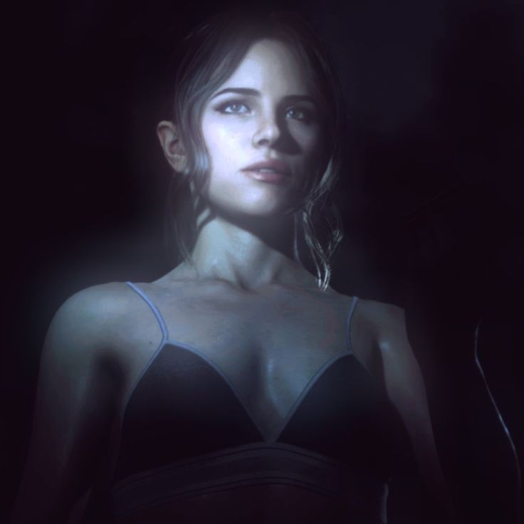 a woman wearing a bra in the dark