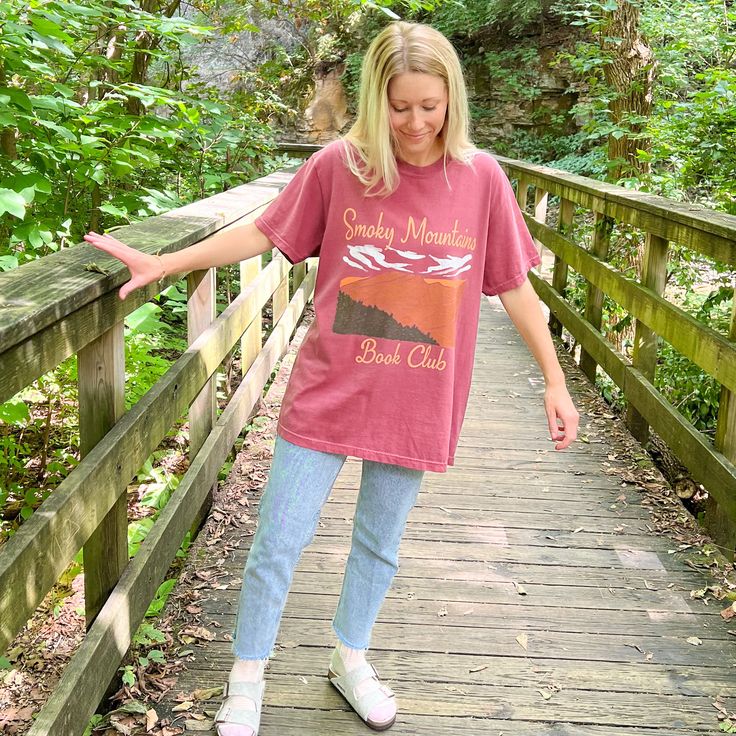 Let's go on an adventure to the National Parks! This bookish tee features an oversized design of the Smoky Mountains on a brick red Comfort Colors tee. It's so comfy, high quality & made to last with a soft, vintage look and feel! You will not want to take it off. Features 100% ring spun cotton Soft washed garment dyed fabric Tee runs slightly big and has a wide boxy throw-back 90s style cut For size guide, view comfort colors tee Pictured: I'm 5'5" & wearing a size large. Casual Red T-shirt For Outdoor Activities, Casual T-shirt For Fall Outdoor Activities, Casual Relaxed Fit T-shirt For Hiking, Comfort Colors Tee, 90s Style, Brick Red, Smoky Mountains, Dyed Fabric, Vintage Look