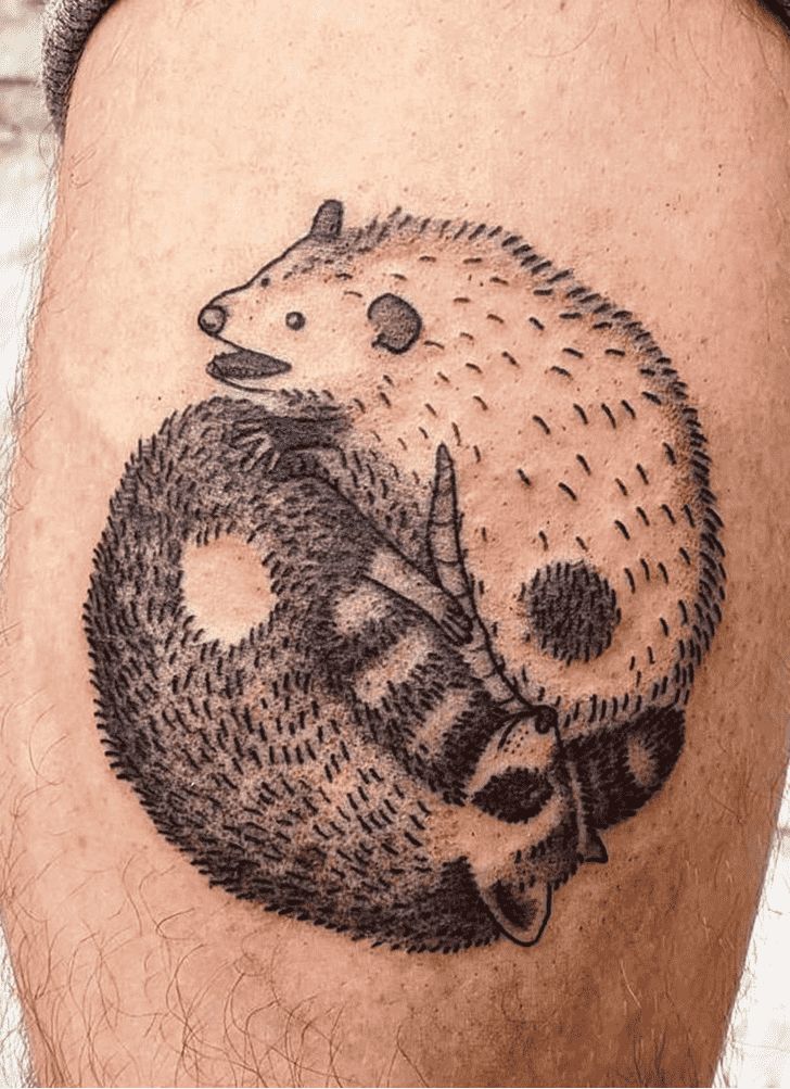 a man with a tattoo on his leg has a hedgehog holding a bagel