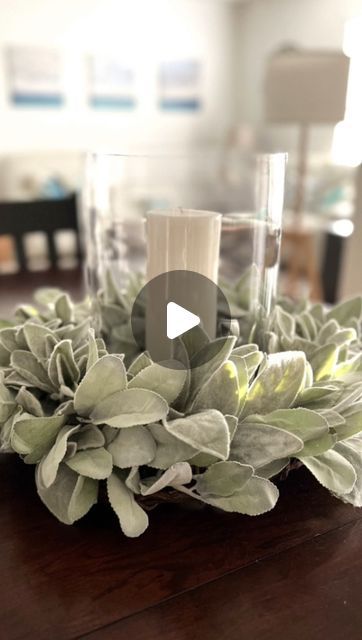 a wooden table topped with plants and candles