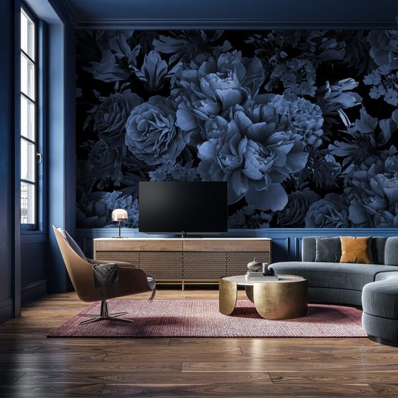 a living room with blue walls and floral wallpaper