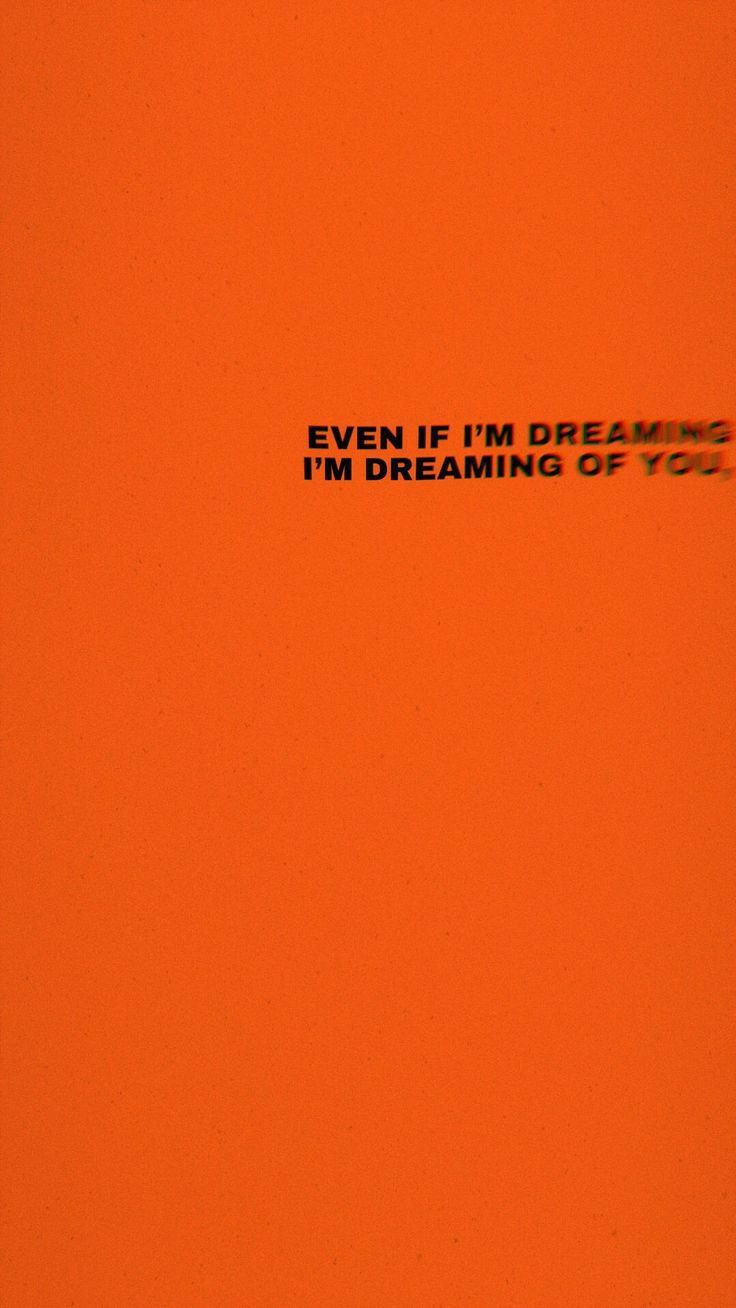 an orange background with the words even if i'm dreaming, i'm dreaming of you