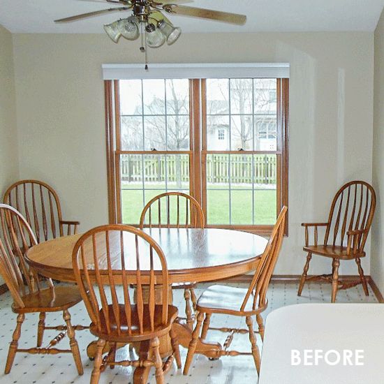 a dining room table and chairs in front of a fire place with a chandelier hanging from the ceiling