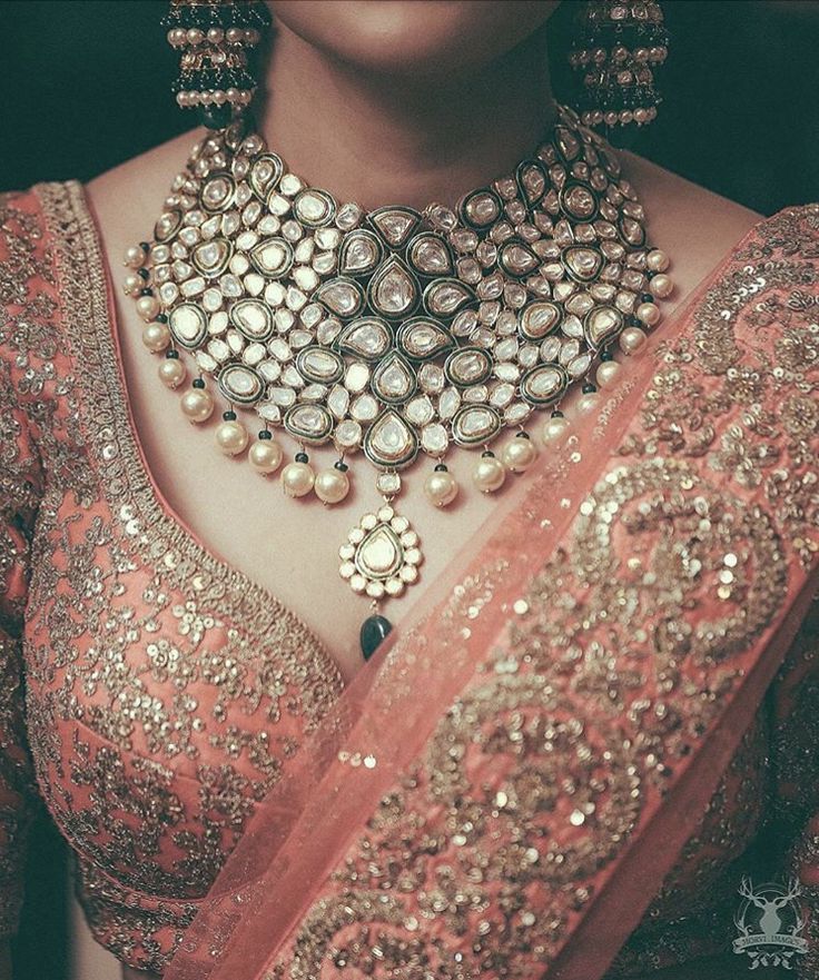 a woman wearing an elaborate necklace and earrings