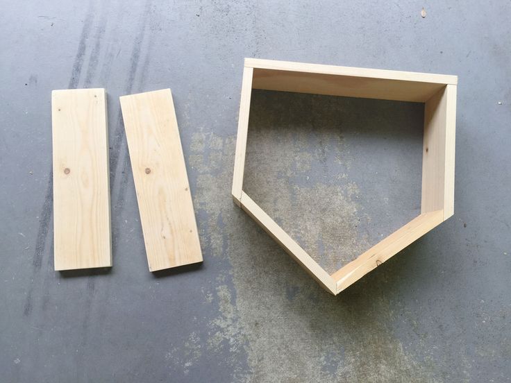 two pieces of wood are laying next to each other on the floor, with one piece missing