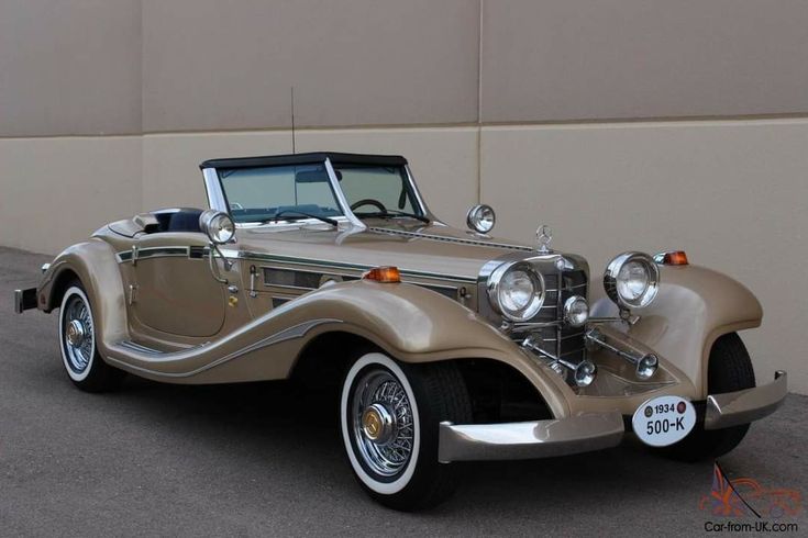 an antique car parked in front of a building