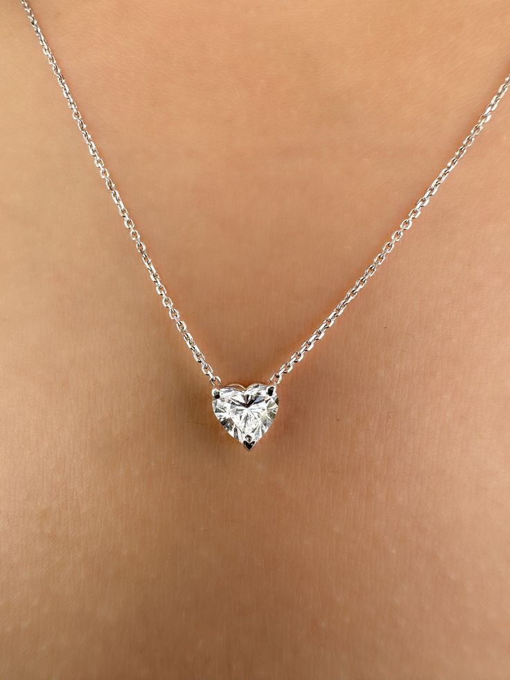 This Beautiful timeless floating diamond pendant is set with a lab-grown heart-shaped diamond in 14k solid gold. It will be the classic perfect gift for any woman in your life--whether she's your wife, girlfriend, fiancée, or bride. The photos show a 0.75ct heart-shaped lab-grown diamond. All of our diamonds are high-quality D color, VS1 clarity. Each diamond is securely set in a Prong setting, radiating sophistication with every glance. Every diamond is expertly positioned to reflect maximum light and brilliance that tells your forever love story. The pendant and chain are made of 14k solid gold and feature a spring clasp. Our collection offers a variety of sizes and carat weights to suit diverse preferences. For the heart diamond pendant Choose from diamonds ranging from 0.5 carats measu White Gold Heart Pendant Necklace With Single Diamond, Classic Sterling Silver Heart Diamond Necklace, Classic Diamond Necklace With Heart Charm For Wedding, White Gold Heart Pendant Diamond Necklace, Classic Diamond White Necklace With Heart Charm, Classic Wedding Diamond Necklace With Heart Charm, Classic Single Diamond Heart Necklace Gift, Classic Diamond Cut Heart Necklace For Anniversary, Classic Diamond Necklace With Heart Charm As Gift