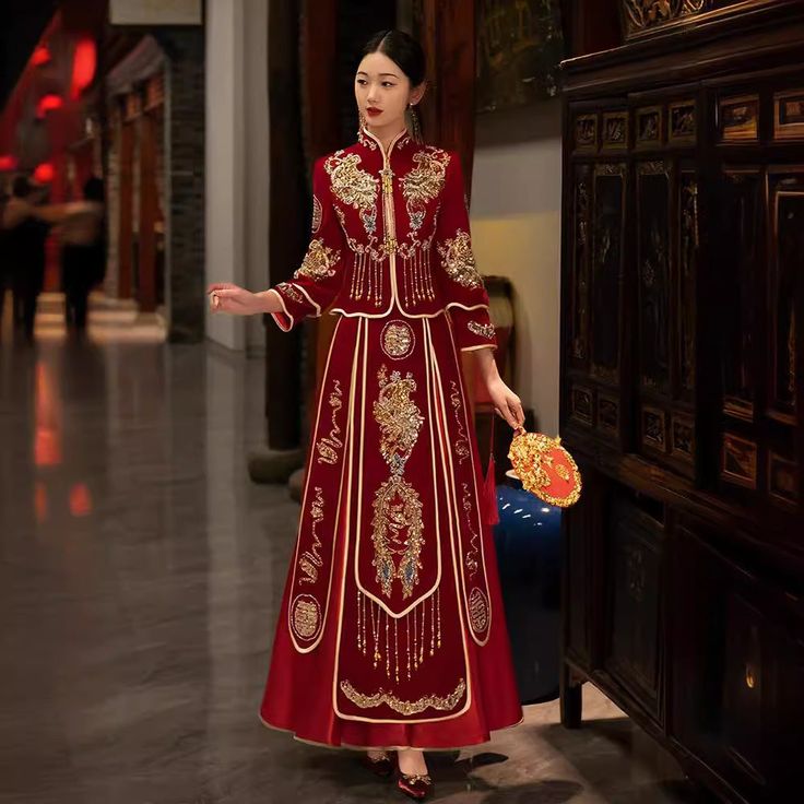 a woman in a red and gold chinese dress