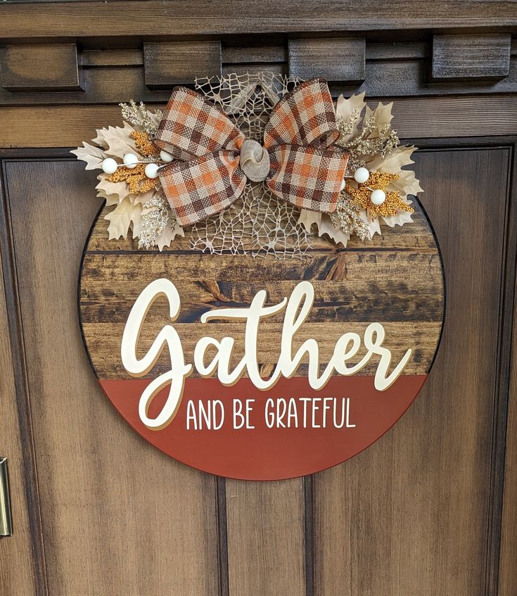 a wooden door with a sign that says gather and be grateful hanging on it's side