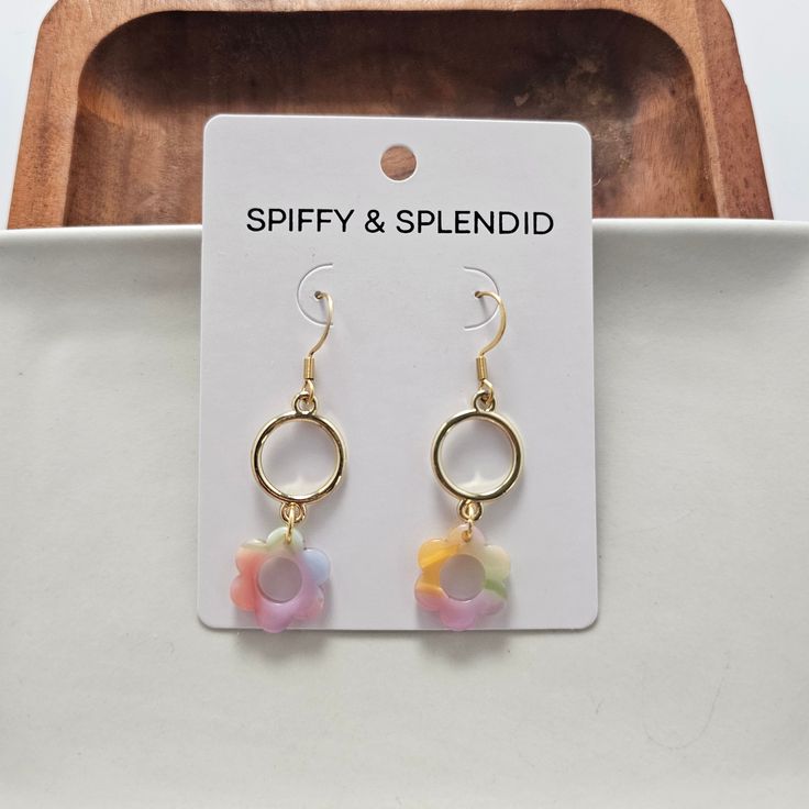 Bloom in style with these darling Poppy Earrings! Featuring dainty flowers, these earrings are the perfect way to add some flower power to any outfit. Stand out with this unique and cute accessory. 18K gold-plated hypoallergenic stainless steel hooks Gold alloy metal circle charms Lightweight and durable plant-based acetate acrylic Color varies from pair to pair, so what you get will be a complete surprise. Colors range from all colors of the rainbow in a pastel hue. Trendy Gold Flower Charm Earrings, Trendy Flower-shaped Earrings For Gift, Trendy 14k Gold Filled Drop Earrings, Trendy 14k Gold-filled Drop Earrings, Trendy Dangle Flower Earrings As Gift, Trendy Nickel Free Flower Shaped Earrings, Trendy Nickel-free Flower-shaped Earrings, Trendy Handmade Gold Flower Earrings, Cute Flower Shaped Hypoallergenic Earrings