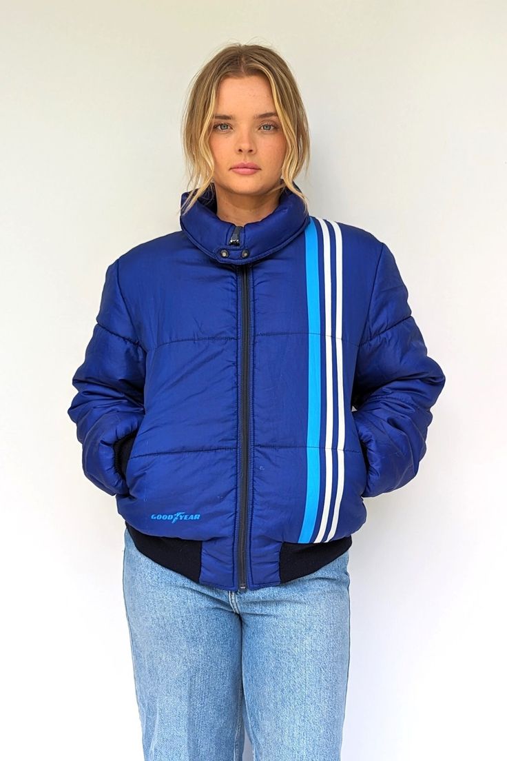 Soft vintage royal blue puffer in great condition. Made for Goodyear, it has zip pockets to the front, a little tuck in hood and is still nicely padded for its age.  Size: UK 12-14, Europe 40-42, US 8-10 Measurements: Bust 41 Inches, Sleeve 26 Inches, Shoulder to Shoulder 19 Inches, Length 26.5 Inches Era: 80s Material: Polyester Brand: Goodyear, Made in Italy Condition: Vintage - with a few little snags or marks, nothing overly noticeable, see last photo for example of mark on the back of the s Blue Nylon Puffer Jacket For Streetwear, Blue Nylon Puffer Jacket With Padded Collar, Blue Puffer Jacket With Zipper For Winter, Blue Puffer Jacket With Zipper Closure For Winter, Blue Winter Puffer Jacket With Zipper Closure, Casual Blue Quilted Puffer Jacket, Blue Quilted Puffer Jacket For Cold Weather, Blue Nylon Sporty Puffer Jacket, Blue Puffer Jacket With Padded Collar For Winter