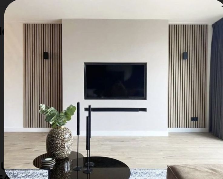 a living room with a large flat screen tv on the wall