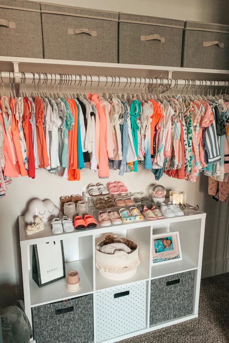 an organized closet with clothes and shoes